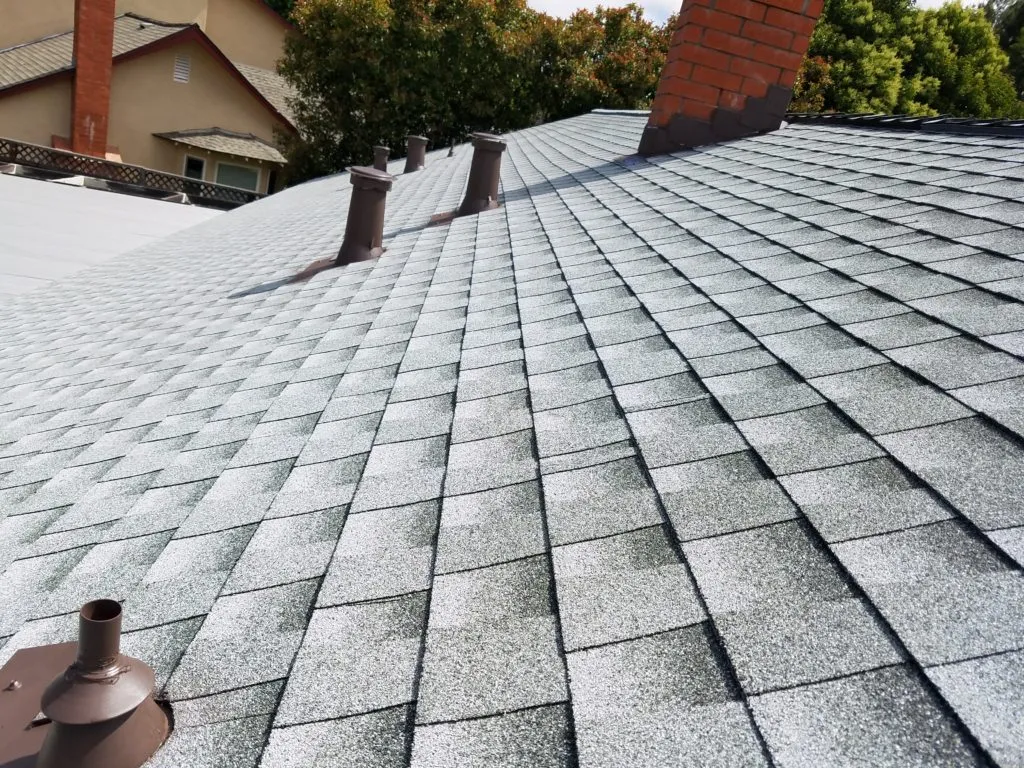 Close-up view of a neatly installed shingle roof with multiple vents by PRI-Premiere Roofing Inc. in Livermore.